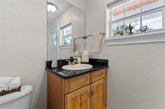 bathroom featuring vanity and toilet