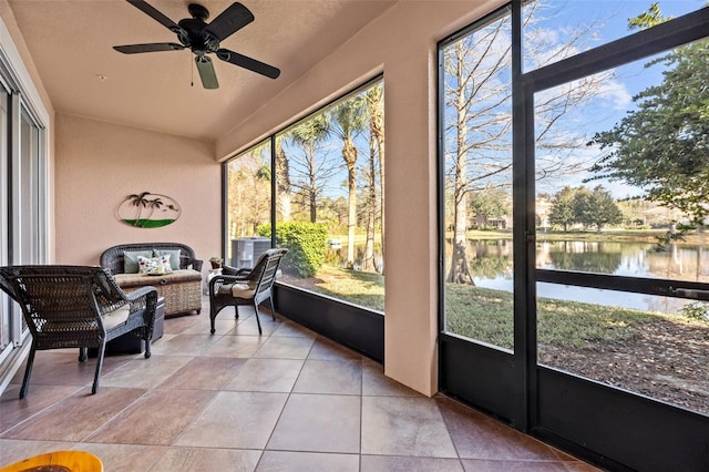 sunroom with a water view and ceiling fan