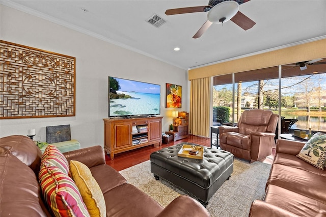 living room featuring hardwood / wood-style flooring, ceiling fan, and ornamental molding