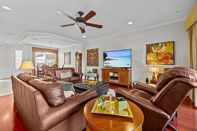 living room featuring ceiling fan, hardwood / wood-style floors, and ornamental molding