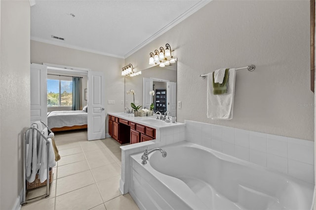 bathroom featuring crown molding, tile patterned flooring, a tub to relax in, and vanity