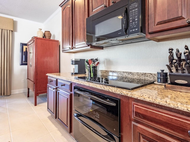 kitchen with light stone counters, light tile patterned floors, black appliances, and ornamental molding