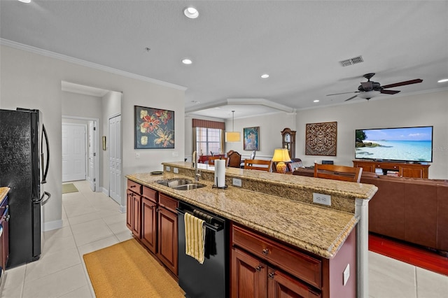 kitchen with dishwasher, sink, light tile patterned floors, an island with sink, and black fridge