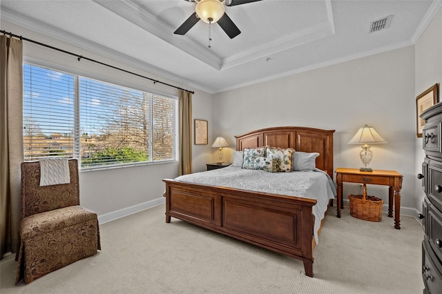 bedroom featuring ceiling fan, a raised ceiling, ornamental molding, and light carpet