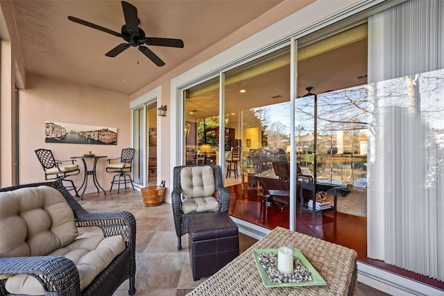 sunroom / solarium featuring ceiling fan