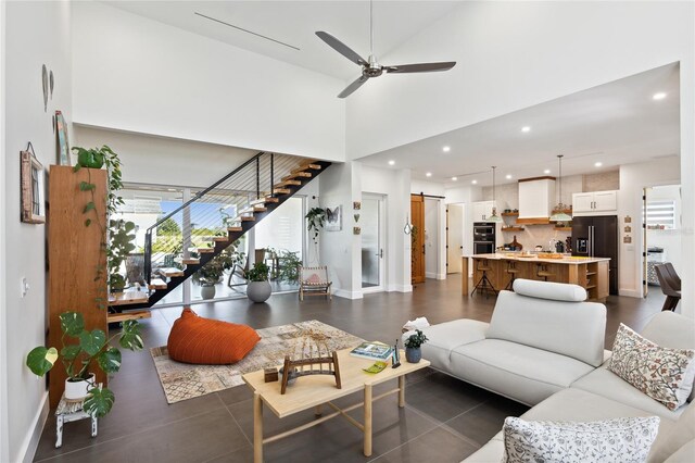 3705 Ridge Run Dr, Minneola, FL 34715 - living room with ceiling fan, a barn door, stairs, recessed lighting, and a towering ceiling