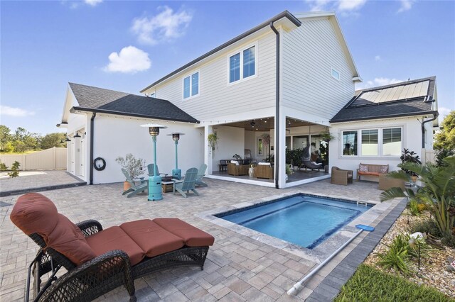 3705 Ridge Run Dr, Minneola, FL 34715 - rear view of house with fence, a shingled roof, an outdoor hangout area, stucco siding, and a patio area