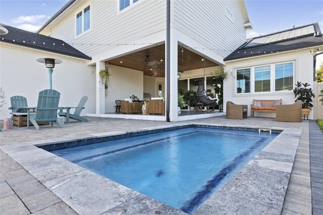 3705 Ridge Run Dr, Minneola, FL 34715 - back of property featuring solar panels, stucco siding, a patio area, and an outdoor pool