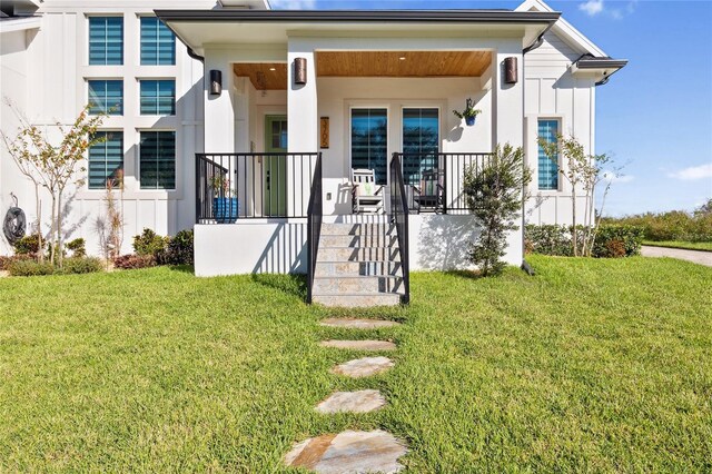 3705 Ridge Run Dr, Minneola, FL 34715 - exterior space featuring covered porch, board and batten siding, and a yard