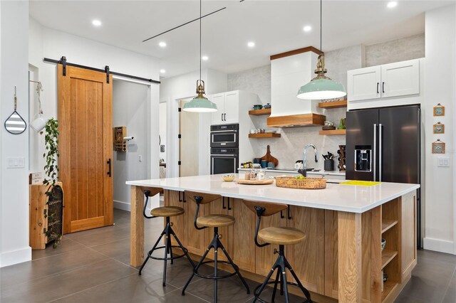 3705 Ridge Run Dr, Minneola, FL 34715 - kitchen featuring open shelves, a barn door, dobule oven black, high end refrigerator, and tasteful backsplash