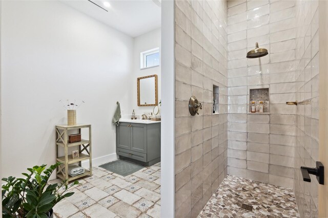 3705 Ridge Run Dr, Minneola, FL 34715 - bathroom featuring baseboards, a tile shower, and vanity