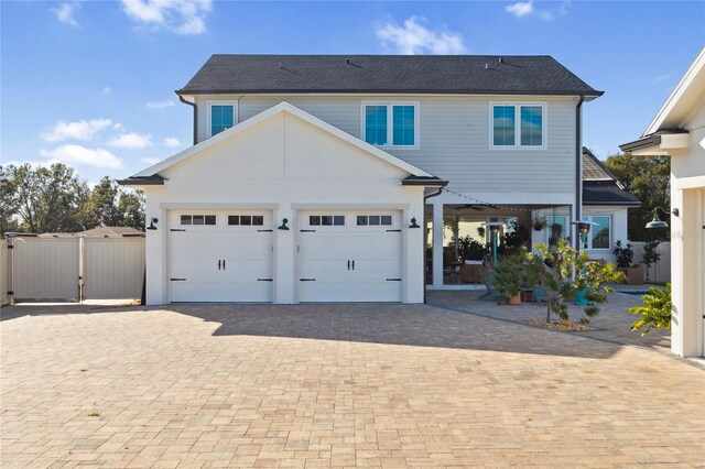 3705 Ridge Run Dr, Minneola, FL 34715 - view of front facade featuring a garage, a gate, decorative driveway, and fence
