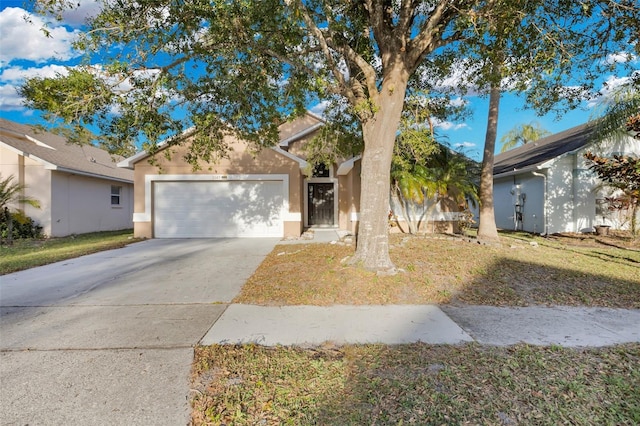 view of front of property with a front lawn and a garage