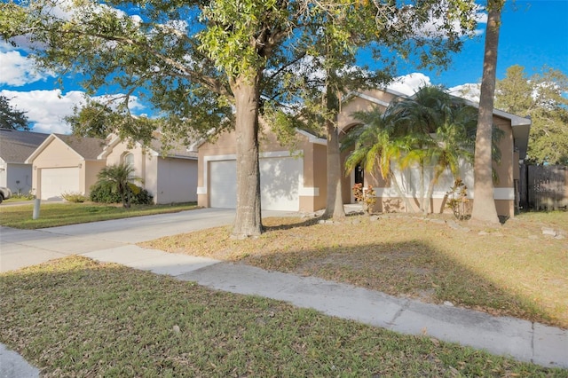 view of front of home featuring a front yard and a garage