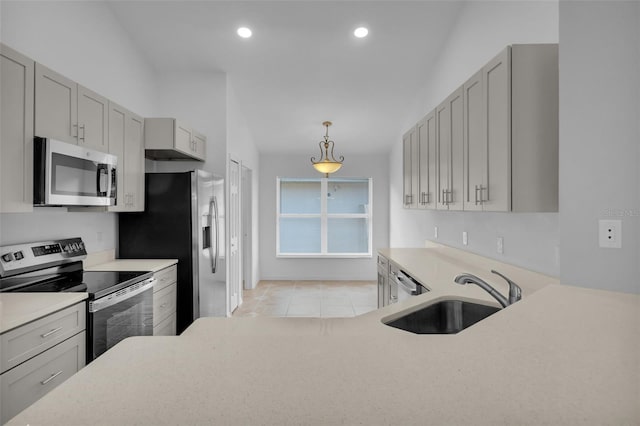 kitchen with pendant lighting, gray cabinetry, sink, light tile patterned flooring, and stainless steel appliances