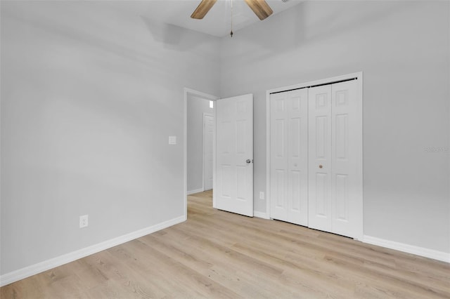 unfurnished bedroom featuring a closet, light hardwood / wood-style flooring, and ceiling fan