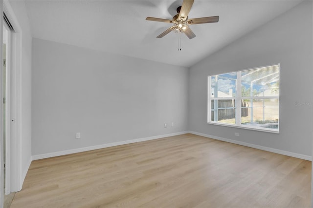 spare room featuring ceiling fan, light hardwood / wood-style floors, and lofted ceiling