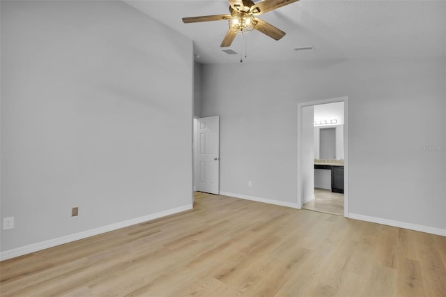 spare room with light hardwood / wood-style floors, ceiling fan, and lofted ceiling