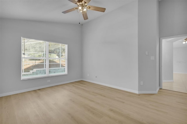 spare room with ceiling fan, high vaulted ceiling, and light hardwood / wood-style floors