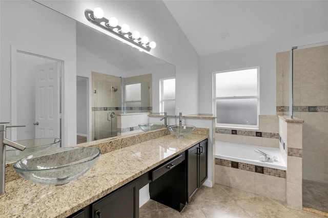 bathroom featuring tile patterned flooring, shower with separate bathtub, vanity, and vaulted ceiling