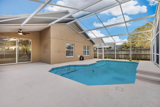 view of pool with a lanai, ceiling fan, and a patio