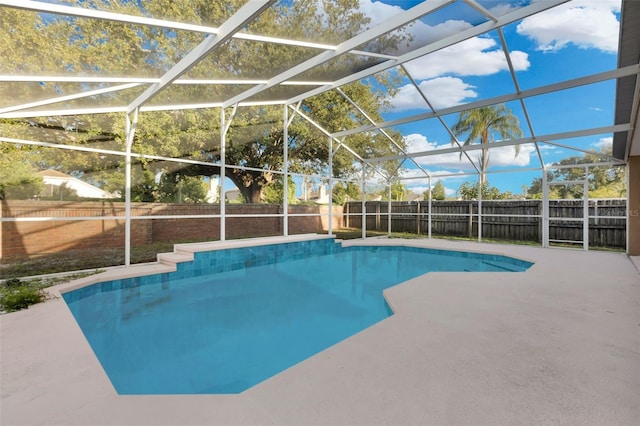 view of pool featuring glass enclosure and a patio