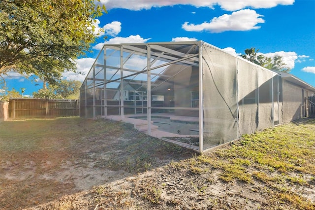 rear view of property with glass enclosure