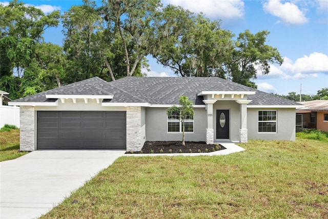 prairie-style house with a garage and a front yard