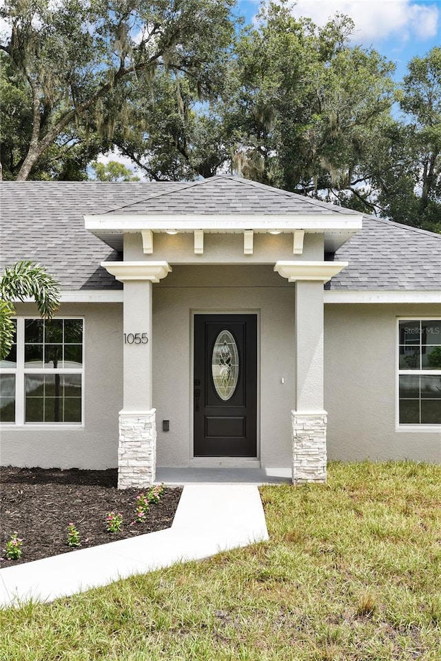 doorway to property with a yard