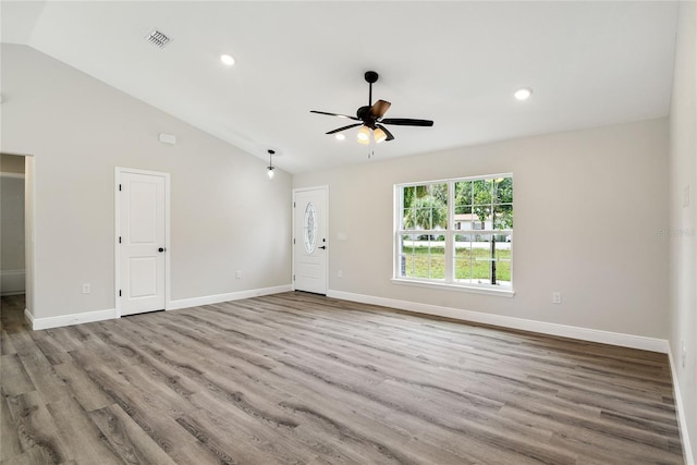 interior space with ceiling fan, light hardwood / wood-style floors, and vaulted ceiling