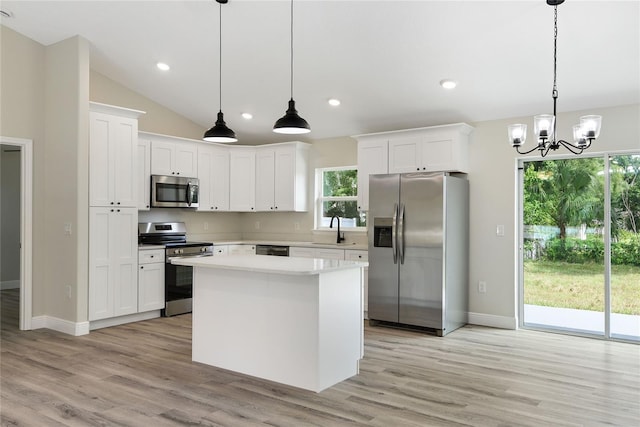 kitchen featuring white cabinetry, sink, pendant lighting, and appliances with stainless steel finishes