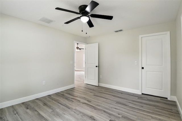 unfurnished bedroom featuring light wood-type flooring and ceiling fan