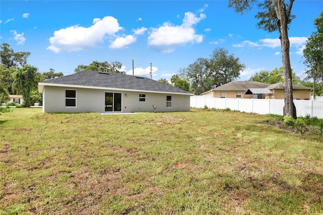 rear view of house with a lawn