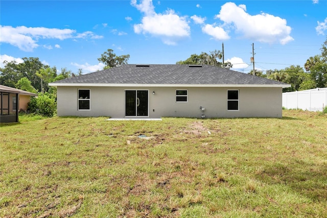 rear view of house with a lawn