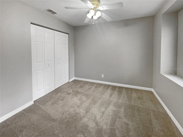 unfurnished bedroom with ceiling fan, carpet floors, and a closet