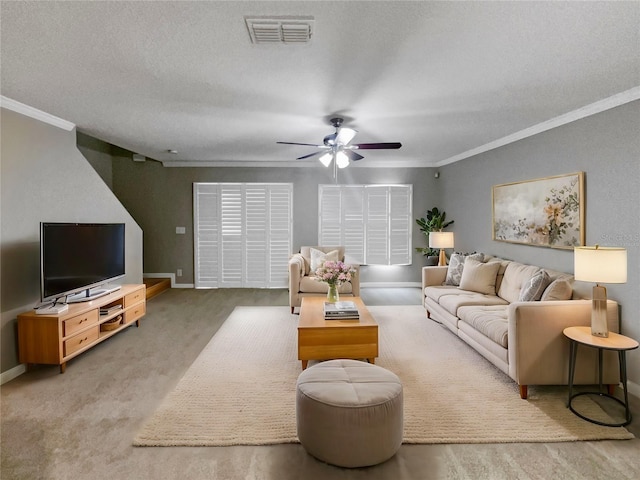 living room featuring ceiling fan, carpet floors, a textured ceiling, and ornamental molding