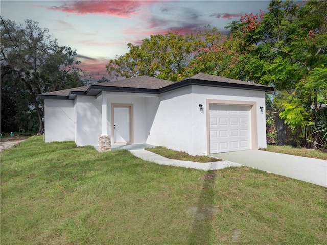 view of front of home featuring a lawn and a garage