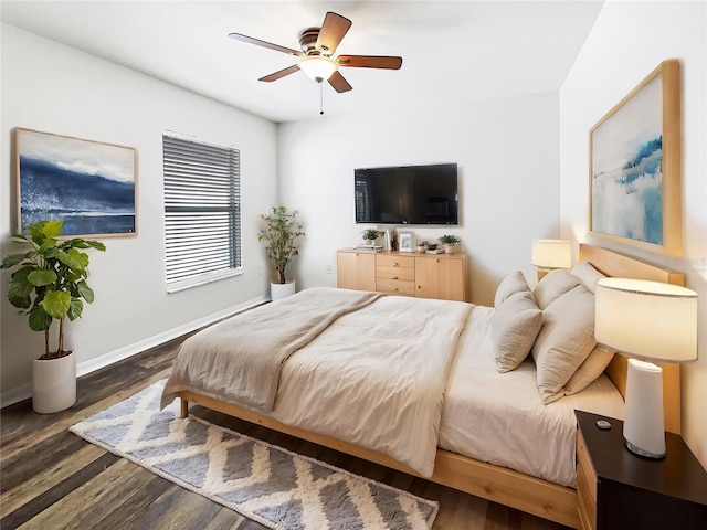 bedroom with ceiling fan and dark wood-type flooring