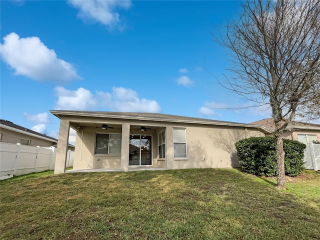 back of house featuring a patio area, ceiling fan, and a yard