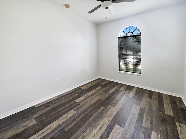 empty room with ceiling fan and dark wood-type flooring