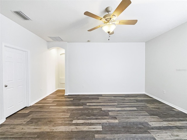 empty room featuring ceiling fan and dark hardwood / wood-style floors