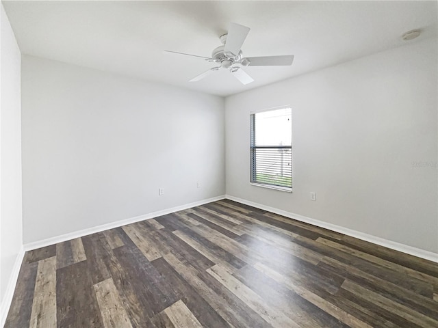 spare room with dark hardwood / wood-style flooring and ceiling fan