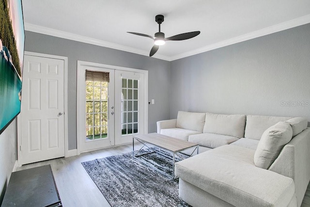 living room featuring crown molding, ceiling fan, french doors, and light hardwood / wood-style floors