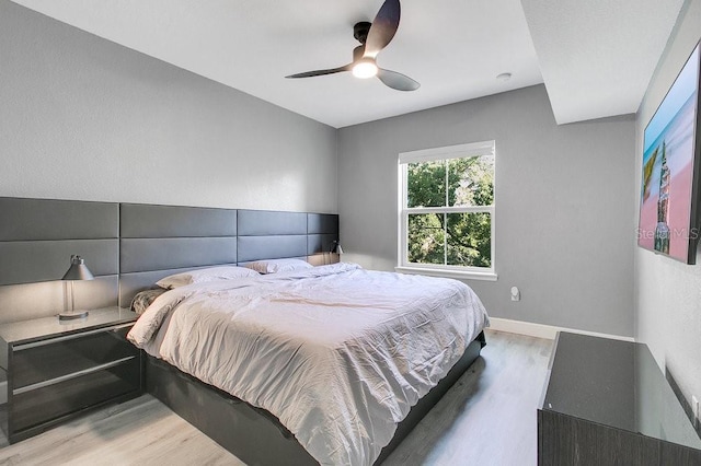 bedroom with ceiling fan and wood-type flooring