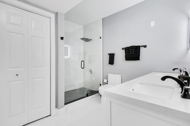 bathroom with an enclosed shower, vanity, and toilet