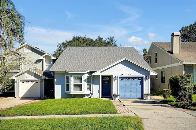 view of front of house with a front yard and a garage