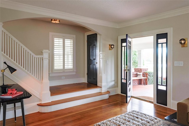 entryway featuring hardwood / wood-style floors and ornamental molding