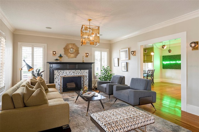 living room featuring a fireplace, crown molding, and a healthy amount of sunlight