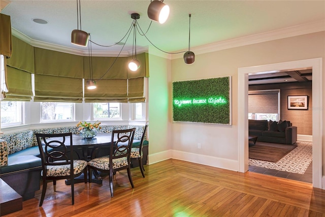 dining room with ornamental molding and wood-type flooring