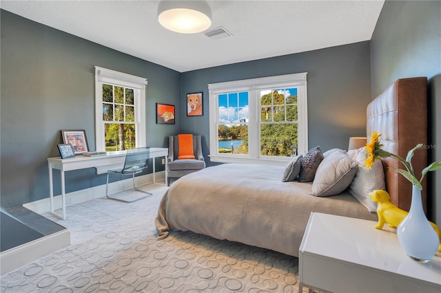 bedroom featuring light colored carpet